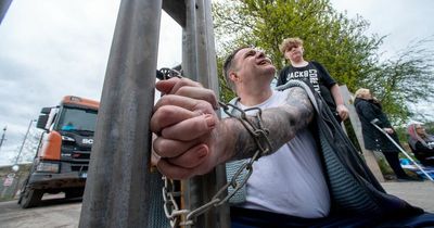Man superglues his own hands together AND padlocks himself to gate in extreme protest