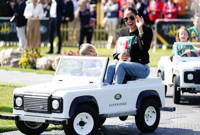 Harry and Meghan go for a spin in mini cars driven by children at Invictus Games