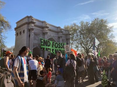 Two people climb Marble Arch amid protests against fossil fuels