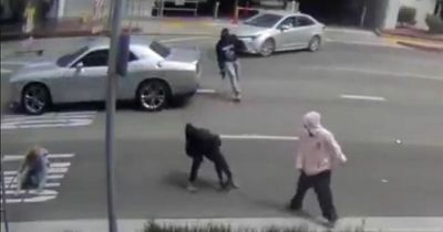 Dramatic moment two armed thieves ram into woman with car as she tries to flee robbery