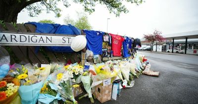 The sea of flowers, football shirts and photos left at the scene of horror crash where two young men died