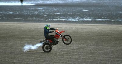 Police helicopters circle biker in 'Mexican standoff' on beach
