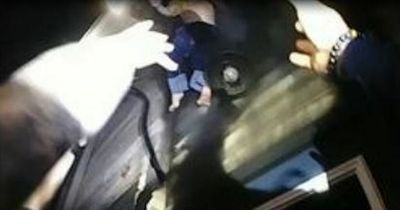 Dramatic moment cops catch two toddlers thrown out of burning building by their mum