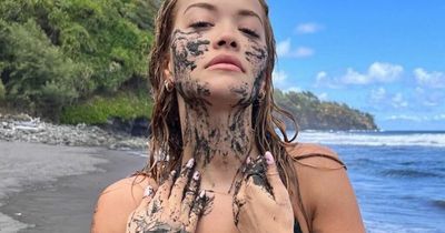 Rita Ora wears black bikini and covers body with mud as she enjoys beach day in Hawaii