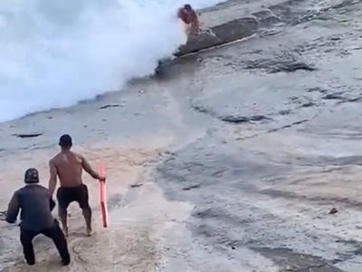 Heart-stopping video shows bodyboarder saving lifeguard in surf contest
