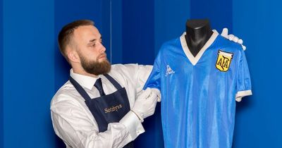 Ally McCoist reacts as Diego Maradona's Hand of God jersey goes up for auction at £4 million