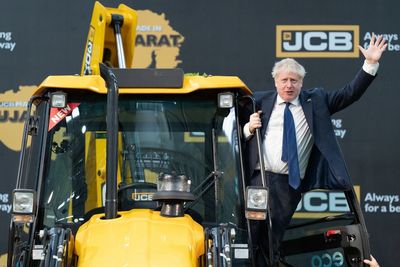 ‘Tone-deaf’ Boris Johnson visits JCB factory amid outcry in India over demolitions using company’s bulldozers