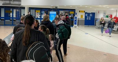 Belfast International Airport passengers experience a frantic morning as queues stretch outside terminal