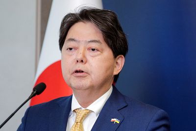 Japan's foreign minister promises a stronger military in visit to US carrier