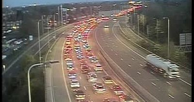 Traffic at standstill near Trafford Centre after trailer overturns on M60