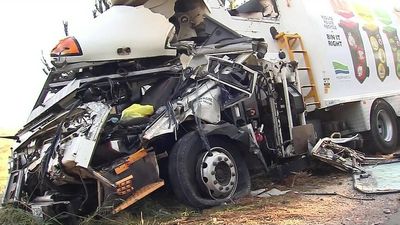 Driver fighting for life after two garbage trucks crash in morning fog west of Melbourne