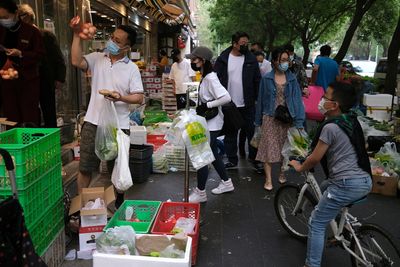 Beijing shoppers throng stores as district starts mass testing