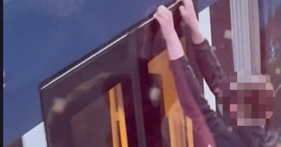 The moment reckless Edinburgh teens cling onto city centre tram in dangerous stunt