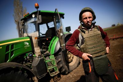 Ukrainian farmers don bulletproof vests to plough frontline fields