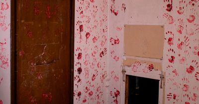 Inside creepy abandoned war hospital with empty room full of eerie red handprints