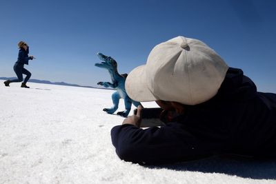 Bolivian boy turns photographer on iconic salt flats - with help from a dinosaur