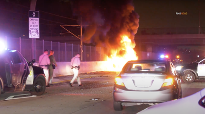 Woman arrested after rear-ending police car, sparking huge fire and leaving three officers injured