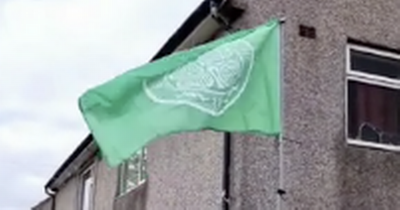 Watch as man plants Celtic flag in Rangers-daft neighbour's garden in Old Firm wind-up