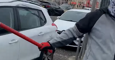 Terrifying moment dad confronted by thugs armed with bats trying to steal his car