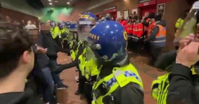Man Utd supporters 'attack' Brentford fans at Old Trafford as riot police step in