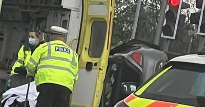 Police swarm street as car hits railings and 'flips over' in Leeds crash