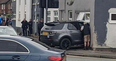 Three people rushed to hospital after Range Rover smashes into building