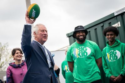 Charles tries American football on visit to charity