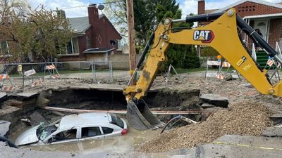 VIDEO: Floody Nuisance: Sinkhole Swallows Car Whole On Waterlogged Street