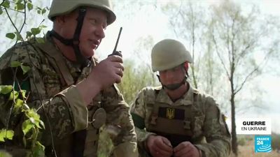 Ukrainian army specialists hunt for explosives left behind by Russian forces
