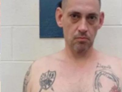 Police share new images of Alabama murder inmate on the run with corrections officer, revealing his Nazi tattoos