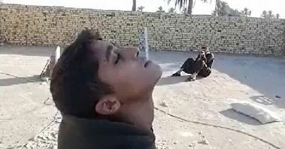 Shocking moment dad recklessly shoots cigarette out of young son's mouth