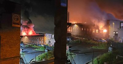 Huge blaze breaks out at tile warehouse in Oldham as more than 50 firefighters rush to scene