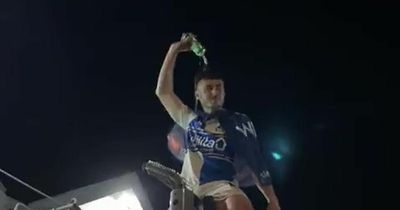 Bristol Rovers star climbs traffic lights and pours beer on head in wild promotion party