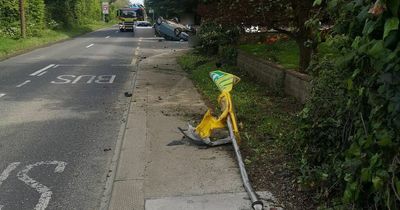 Car flips over in crash and takes out bus stop in the process