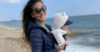 Amanda Byram beams as she poses with baby son during sunny UK beach walk