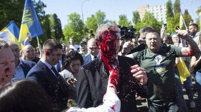 Russian Envoy to Poland Hit with Red Paint at War Cemetery