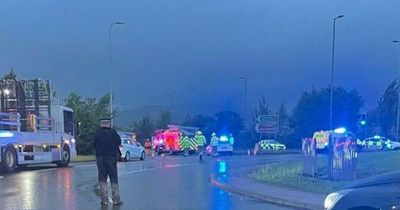 One dead and four rushed to hospital after car strikes workers on major Scots road