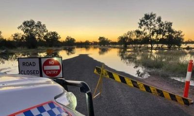 Queensland floods: woman dies after vehicle is swept away as more heavy rain forecast