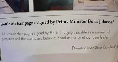 A bottle of champagne signed by Boris Johnson was auctioned as 'a souvenir of partygate'