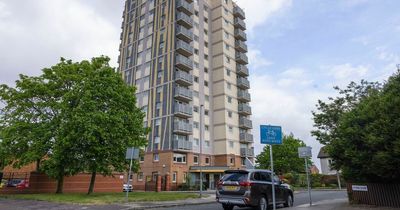 Children laugh and play in street hours after woman found dead in flats