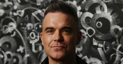 Robbie Williams says painting in his garage 'quiets the voices in his head'