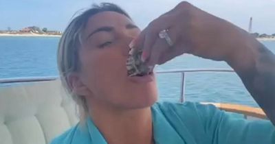 Katie Price sucks down oysters on yacht with Carl Woods after £80 a pop makeup classes