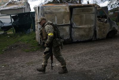 Ukrainian troops holding destroyed village believe Russians withdrawing across border
