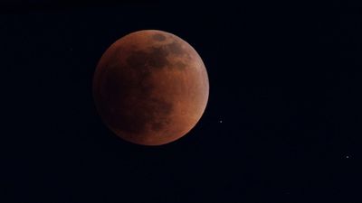 First total lunar eclipse of the year seen around the world, with a super blood Moon emerging from the shadows