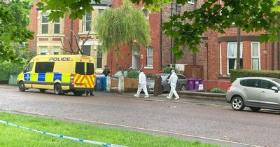People in pyjamas watch helicopter land as police launch murder investigation