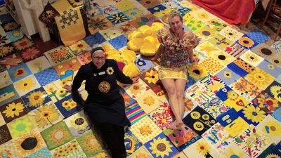 Giant sunflower quilt destined for bombed buildings, muddy graveyards of Ukraine