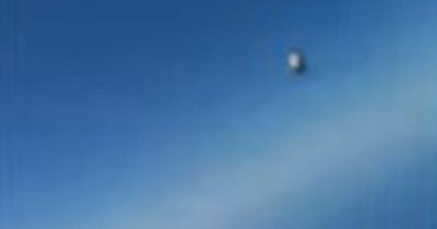 Pentagon releases bizarre new footage of circular UFO zooming past plane in sky