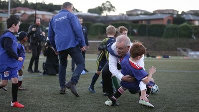 Prime Minister Scott Morrison crashes into a child during soccer training in Tasmania on campaign trail