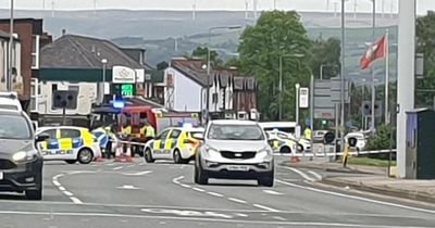 Man rushed to hospital after motorbike and car crash on busy road