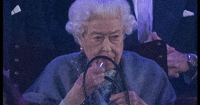 Queen spotted touching up her trademark pink lipstick - and she did it without a mirror